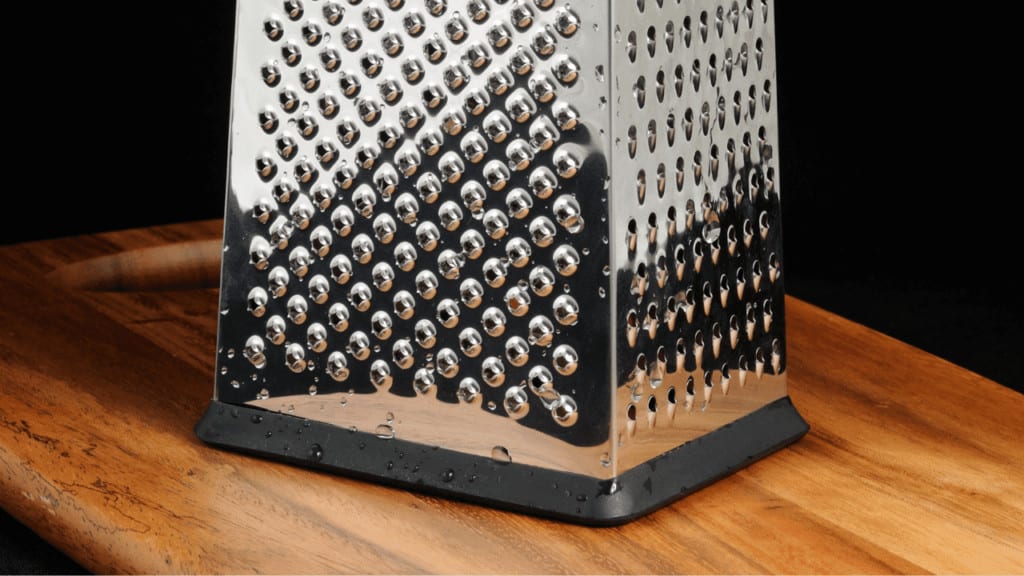 Place a box grater on a cutting board