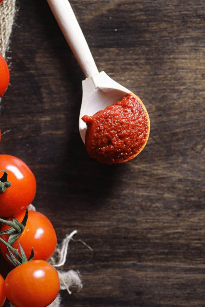 There is nothing unsafe about eating tomato paste raw