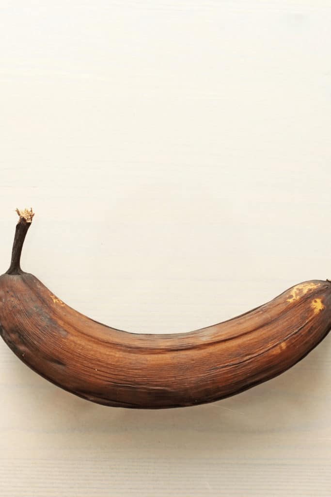 Natural aging can take anywhere between between two and four weeks to reach that “almost rotten” stage for bananas where the skin is almost black