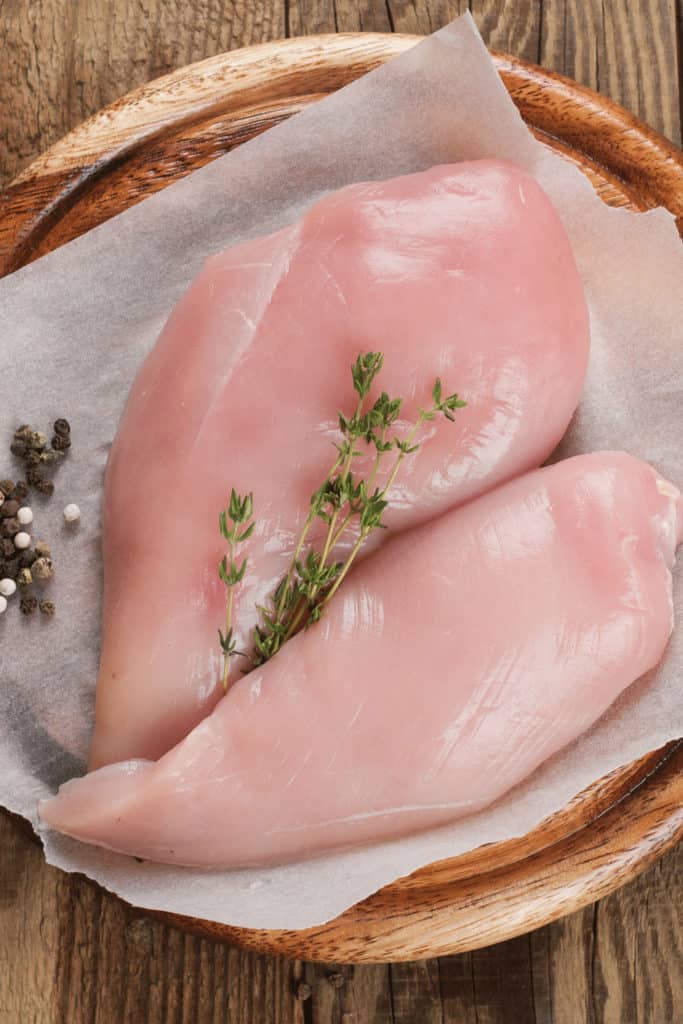 The slime on chicken after defrosting is caused by bacteria that have begun decomposing the chicken