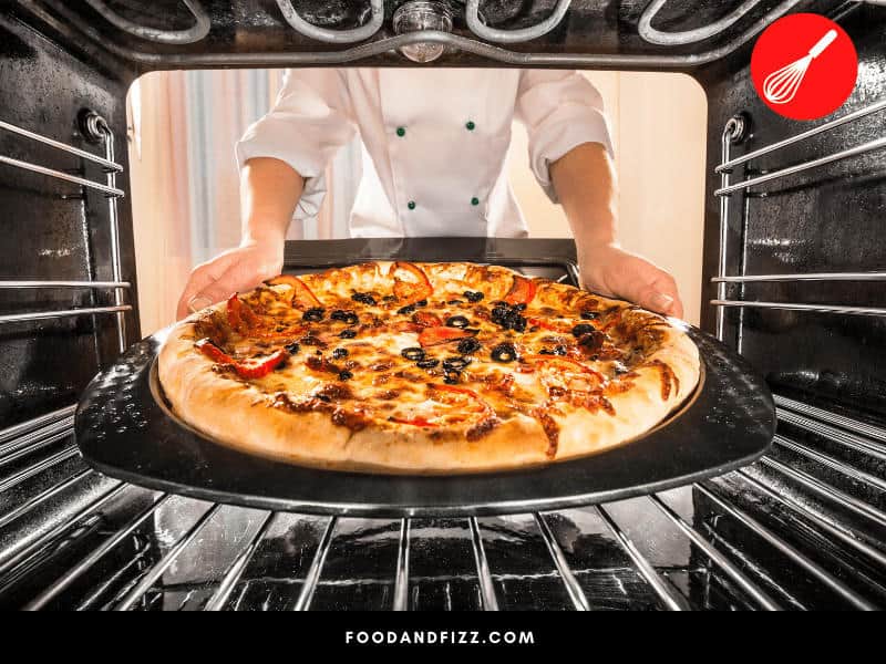 It helps to lower the temperature a little bit if cooking pizza with lots of different cheeses to ensure even melting of all the cheese.