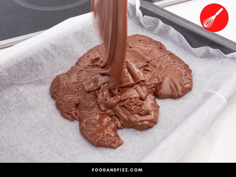 Line pan with parchment paper instead of greasing, and make sure your fudge is at the right temperature before pouring.