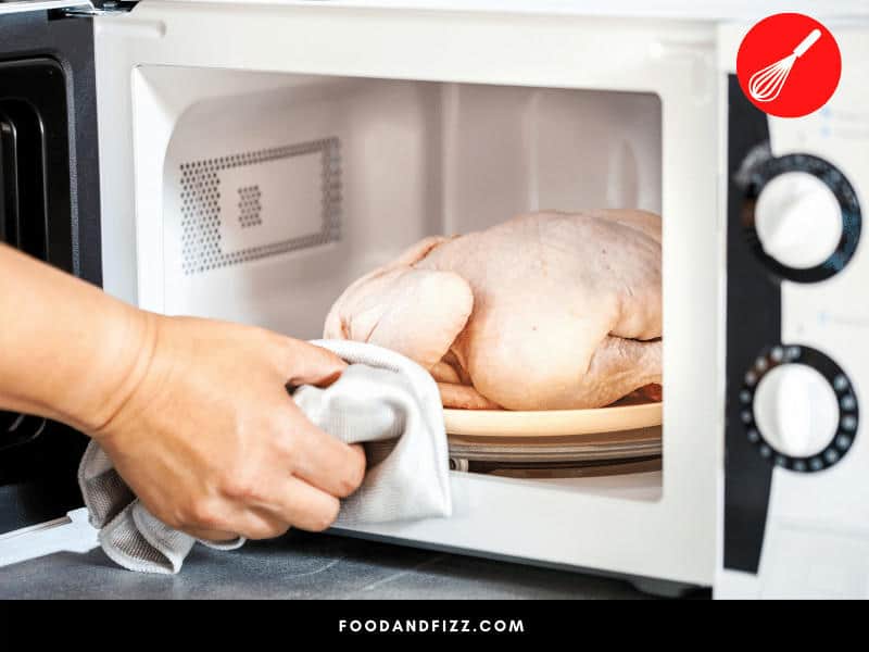 The quickest way to defrost frozen chicken is to use the microwave.