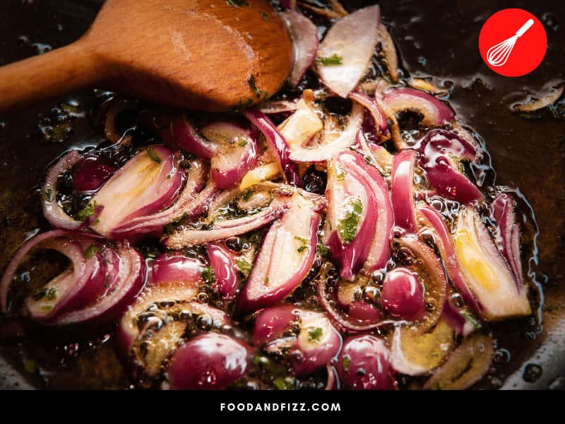 Red onions are acidic. When cooked with acidic ingredients, their purple color will intensify. When cooked with alkaline ingredients, they will turn a blue or green color.