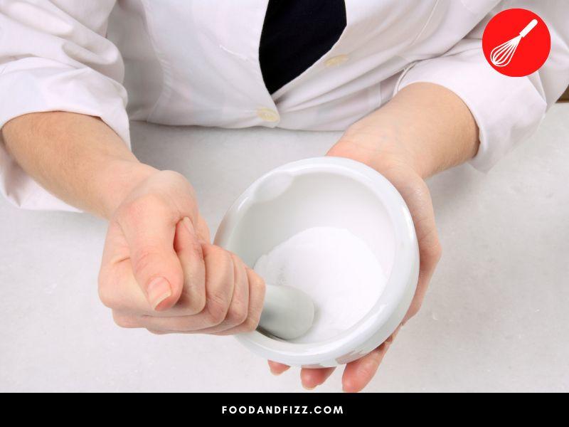 A mortar and pestle can be used to grind your kosher salt.