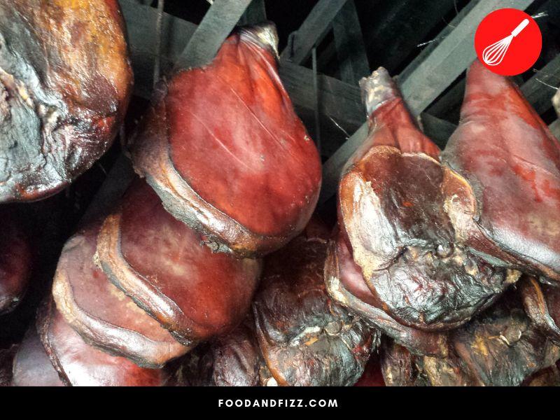 Country hams are typically dry-cured, smoked, and aged for months to years