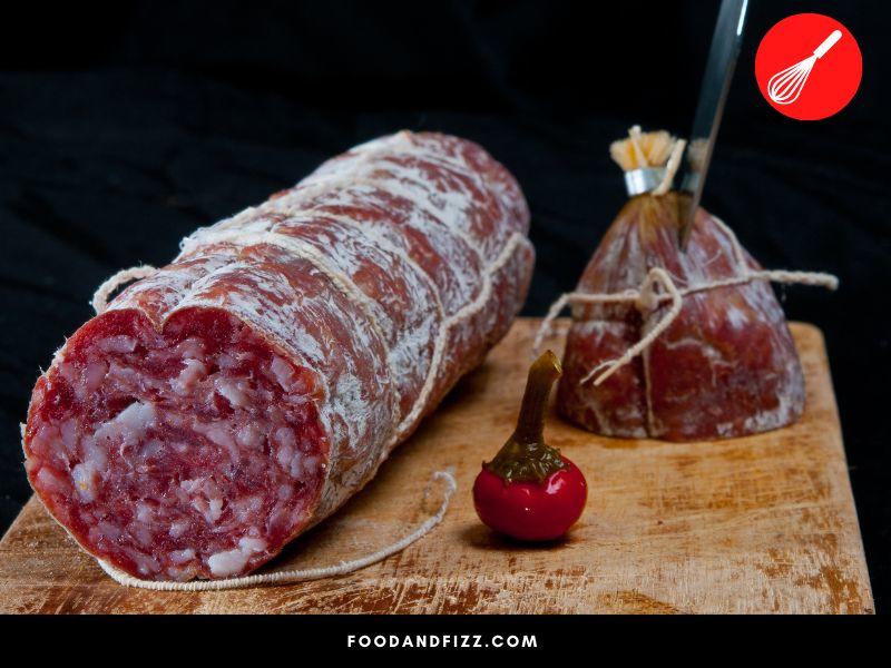Salami is a cured, fermented and dried sausage usually made with pork.